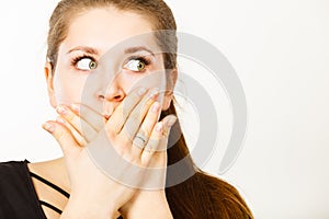 Woman covering her mouth with hand