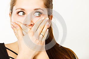 Woman covering her mouth with hand