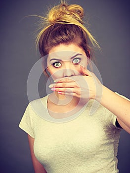 Woman covering her mouth with hand