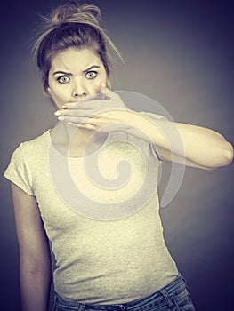 Woman covering her mouth with hand