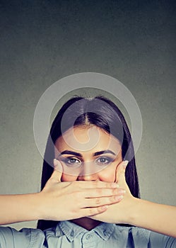 Woman covering her mouth with hands