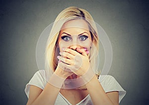 Woman covering her mouth with hands scared to speak out about abuse