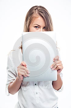 Woman covering her mouth with laptop