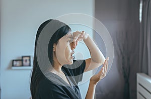 Woman covering her mouth and smell her breath with hands upter wake up,Bad smell