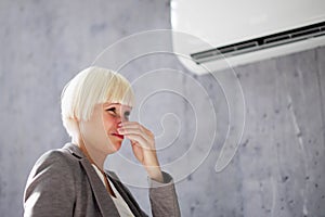 Woman Covering Her Nose From Bad Smell Inside