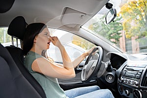 Woman Covering Her Nose From Bad Smell photo