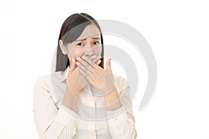 Woman covers her mouth