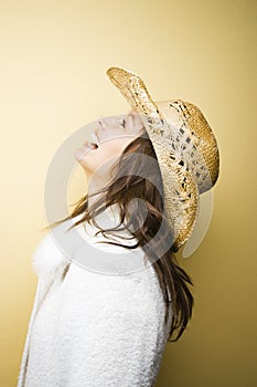 Woman in cowboy hat laughing.