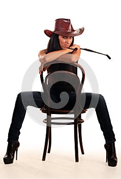 woman in cowboy hat sits on chair