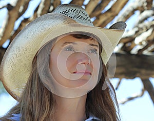 A Woman in a Cowboy Hat Under a Ramada photo