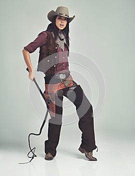Woman, cowgirl and portrait in studio for outfit costume with confidence on white background, weapon or outlaw. Female