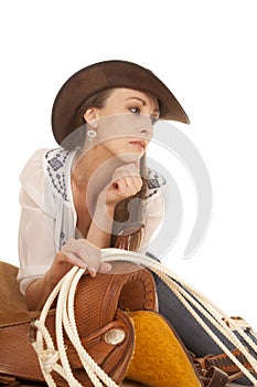 Woman cowgirl white blouse on saddle look side