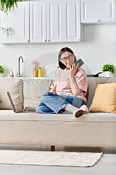 A woman in cozy homewear sits