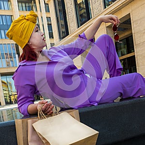 woman with craft shopping bags in the city. The concept of fashionable Consumerism and ecology.