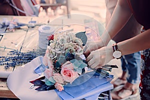 Woman is crafting rose flower bouquet