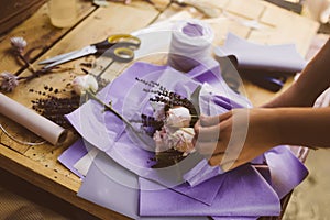 Woman is crafting rose flower bouquet