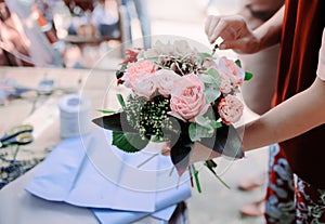 Woman is crafting rose flower bouquet