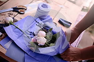 Woman is crafting rose flower bouquet