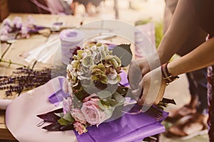 Woman is crafting rose flower bouquet