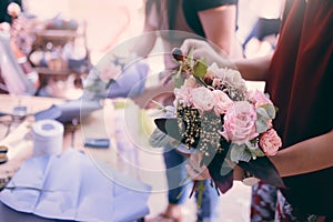 Woman is crafting rose flower bouquet