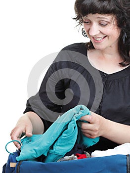 Woman crammed full of clothes and shoulder bag isolated