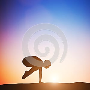 Woman in crane pose yoga pose meditating at sunset. Zen