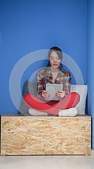 Woman in crative box working on tablet