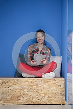 Woman in crative box working on tablet photo