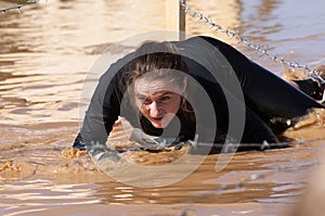 Woman crawling on a mud puddle