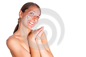 Woman with cream heart on the face