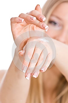 Woman creaming hands
