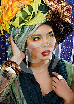 Woman with creative make up, many shawls on head like cubian woman