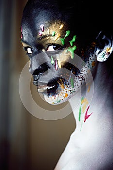 woman with creative makeup closeup like drops of colors, facepai