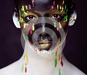 Woman with creative makeup closeup like drops of colors, facepaint close up halloween