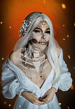 Woman with creative professional makeup Calavera Catrina. a gray-haired witch