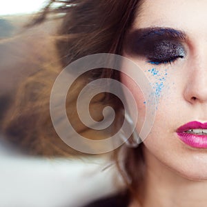 The woman with a creative smoky eyes make-up