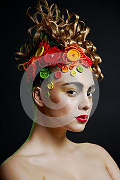 Woman with creativity hairstyle with colored butto