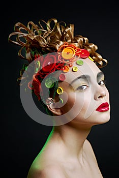 Woman with creativity hairstyle with colored butto