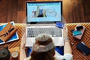 Woman with credit card subscribing to computer courses website photo