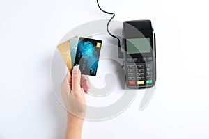 Woman with credit cards and modern payment terminal on white background