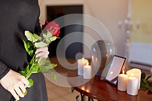 Woman with cremation urn at funeral in church