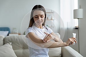 Woman creme holding tube apply cream nourish elbow area
