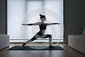 Woman in crescent lunge twist position on mat