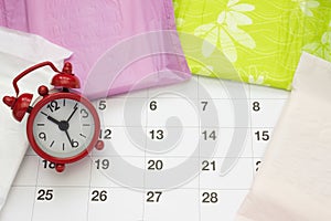 Woman critical days, gynecological menstruation cycle, blood period. Menstrual sanitary soft pads, calendar and a clock. Woman hyg