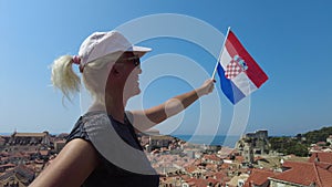 Woman with Croatian flag on Dubrovnik walls