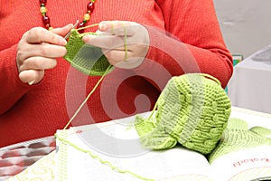 Woman crocheting a bonnet