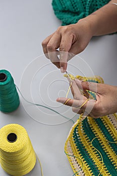 Woman crocheting pattern with crochet hook Close-up