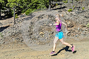 Woman cross country running in mountains