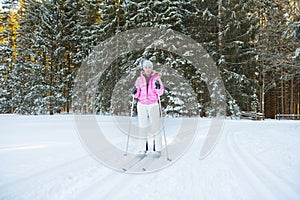 Woman cross country skiing in forest