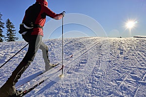 Woman cross-country skiing short before sunset in the Bregenz Forest Mountains